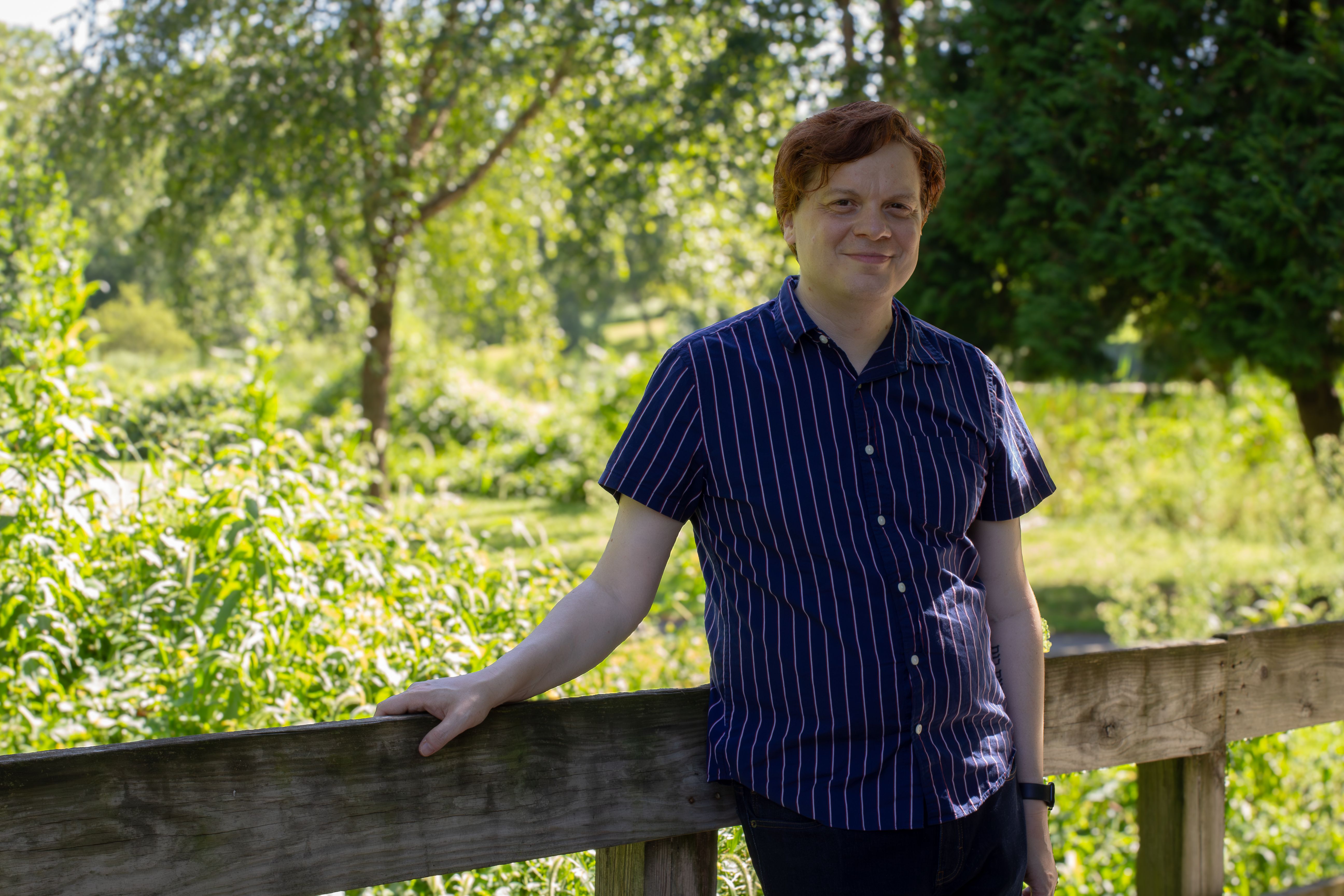Eric Sipple standing on a bridge, leaning on the railing
